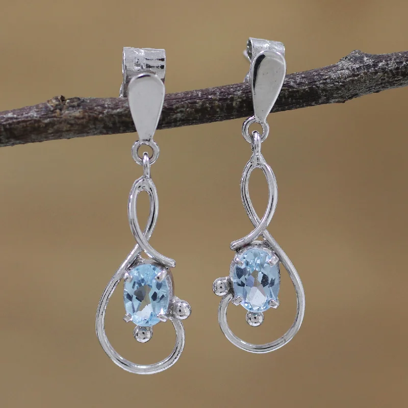 Best hoop earrings with geometric hexagon shapes for a modern, angular look-Beauty Swirls Rhodium Plated Blue Topaz Dangle Earrings from India